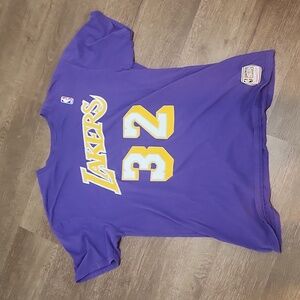 Authentic Mitchell and Ness Magic Johnson warm up jersey.